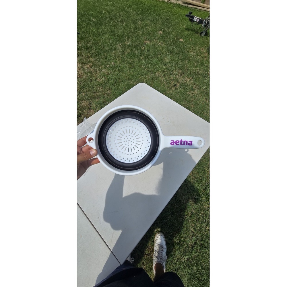 white and black collapsible kitchen strainer or colander Aetna branded handle
